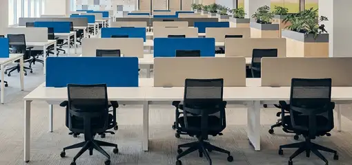 Modern open-plan office space featuring clean workstations, ergonomic chairs, and sanitized carpets provided by professional office cleaning services in Glendale, AZ.