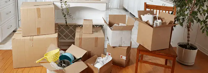 Packed moving boxes and household items in a kitchen before move-out or move-in cleaning, Glendale, AZ.